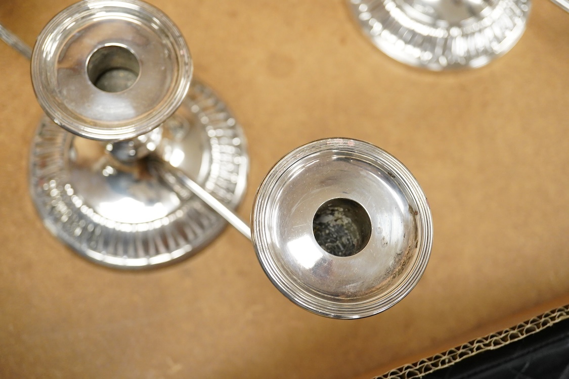 A pair of Elizabeth II silver mounted two branch, three light dwarf candelabra, by George Howson, Sheffield, 1959, height 16.7cm, weighted.